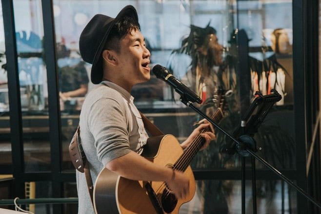 male busker with black bucket hat