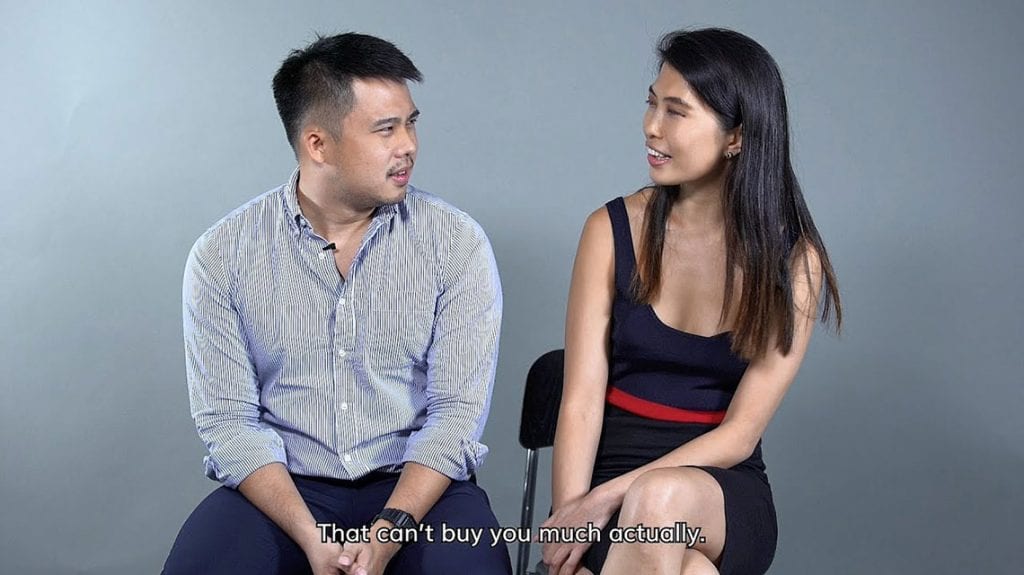 man in blue shirt and woman in blue dress deep in discussion