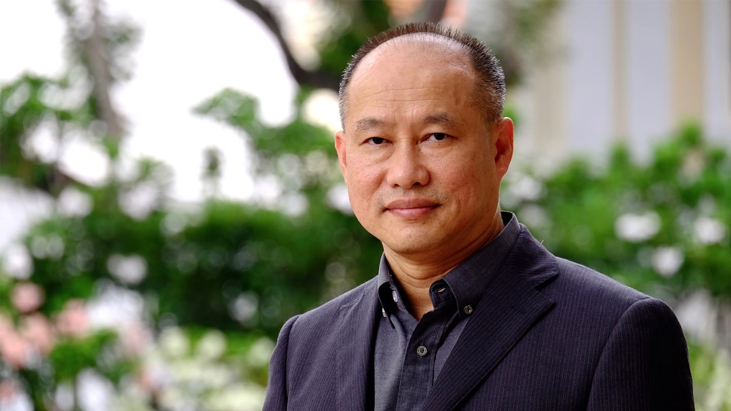 stern-looking man in suit poses for photo