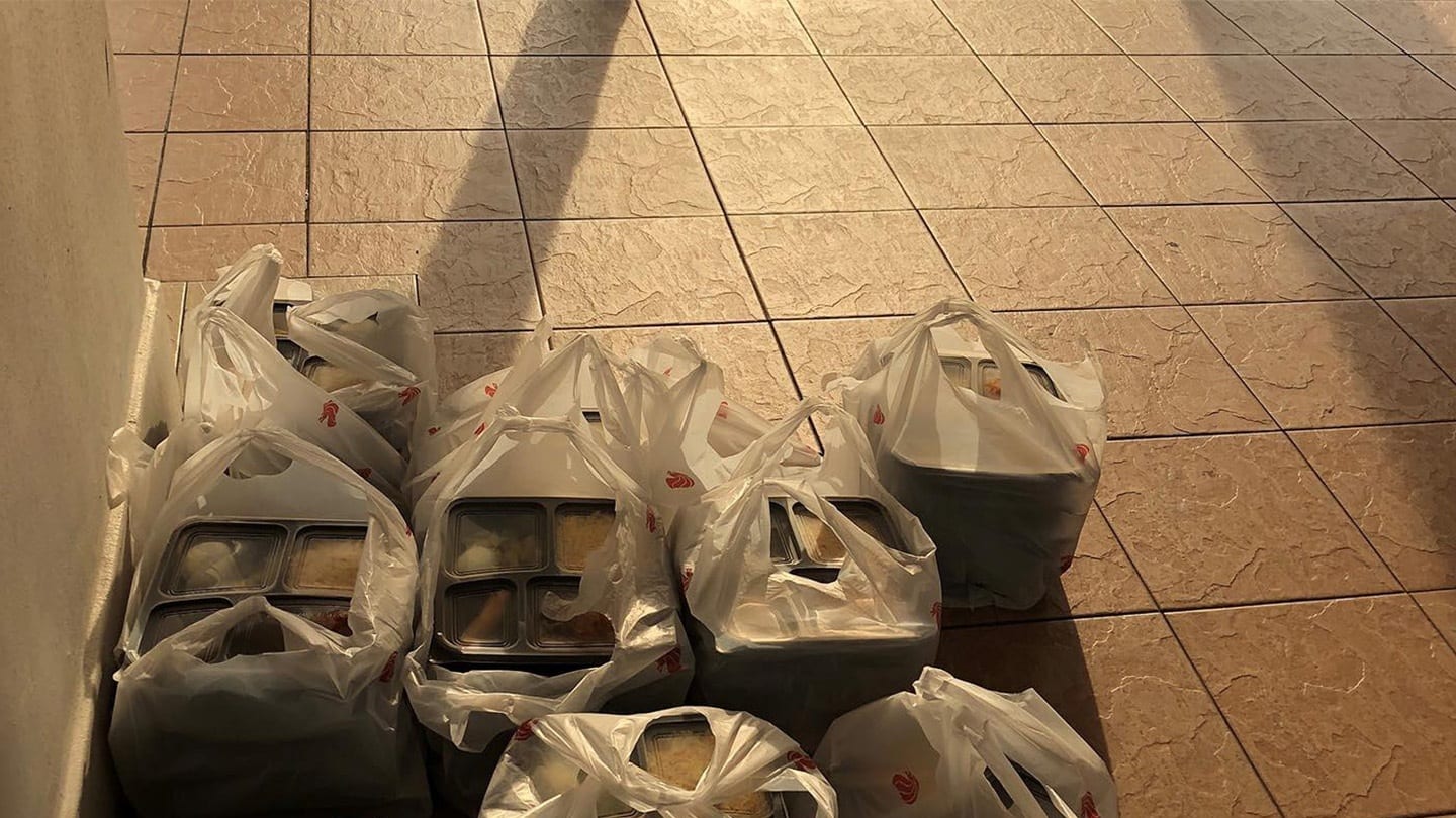 plastic bags of packed food sitting at hdb lift lobby