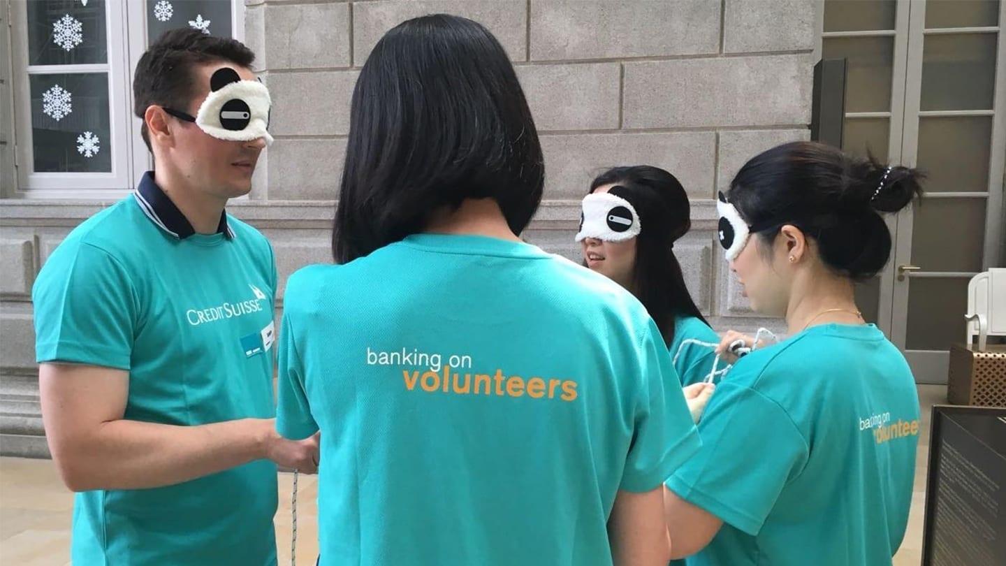 volunteers in turquoise credit suisse shirts