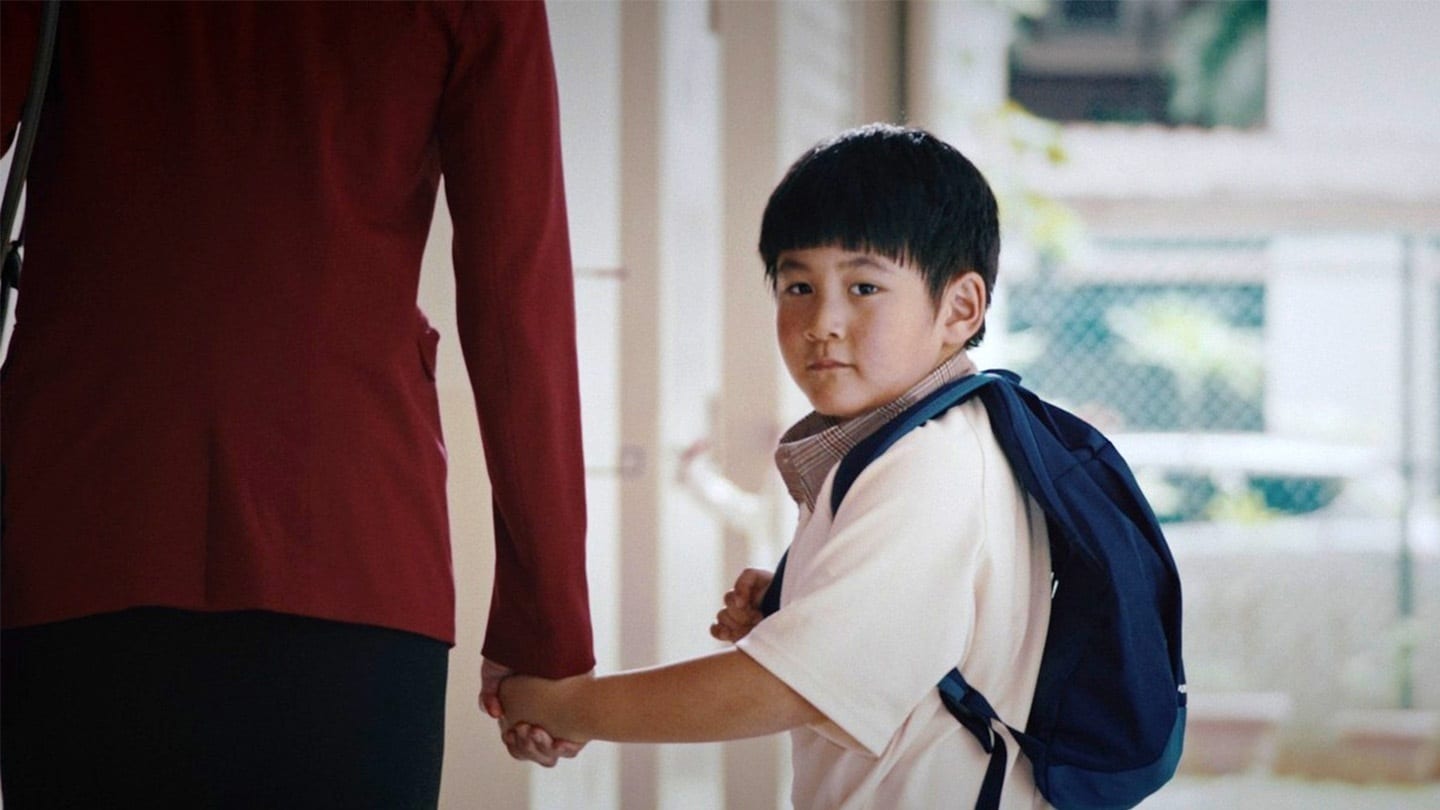 schoolboy turning around to look into camera