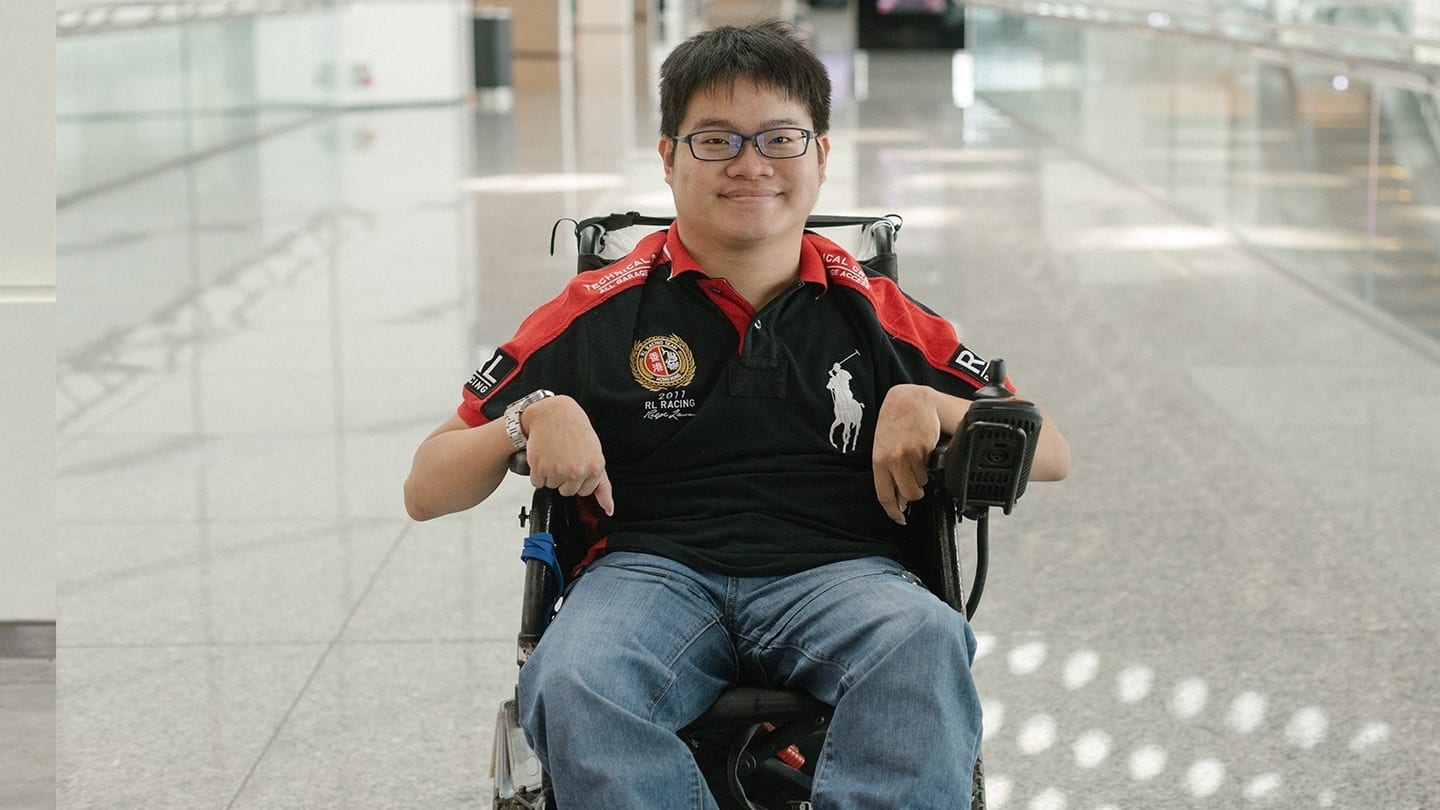 man in black and red ralph lauren polo shirt sitting in a wheelchair