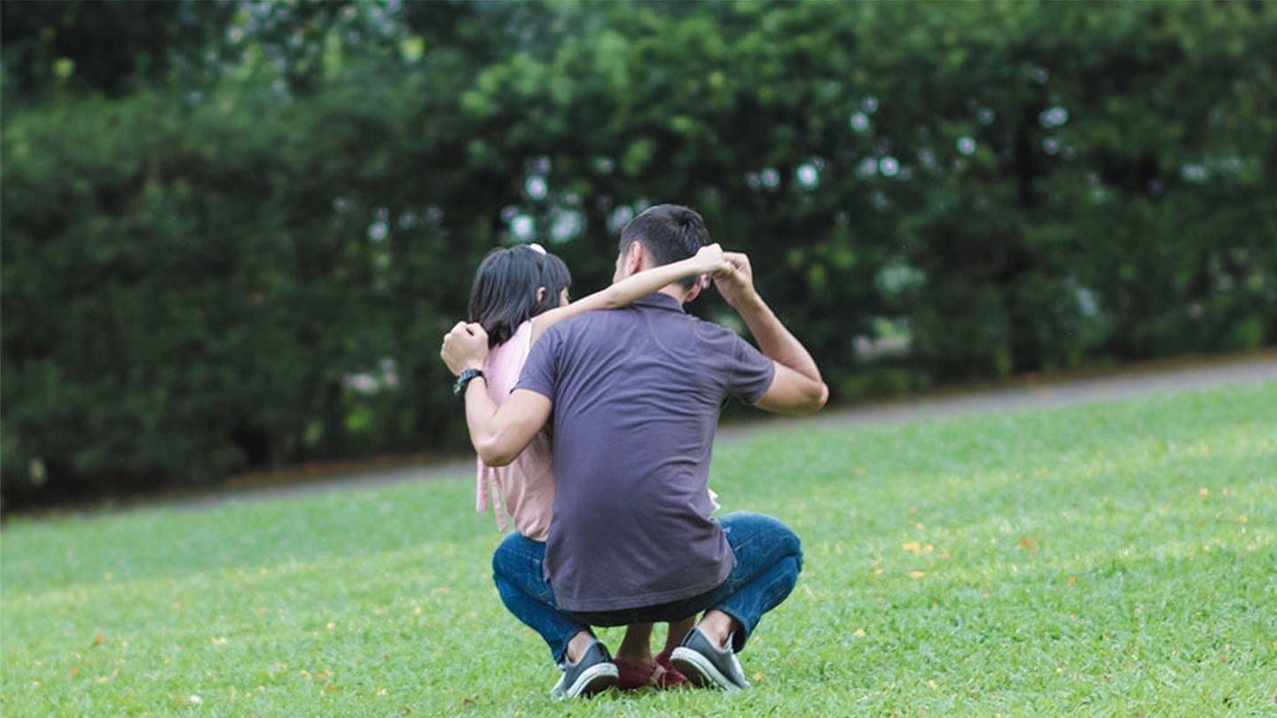 man in grey shirt with short-haired girl in pink shirt