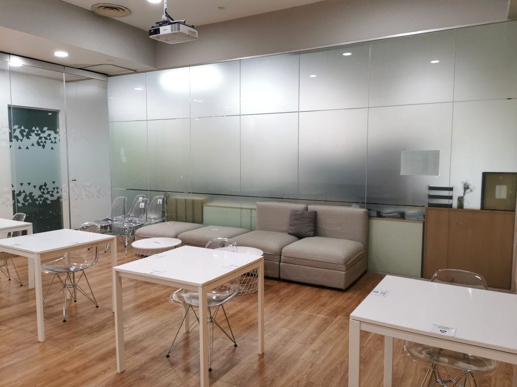 conference room white square tables and grey sofas