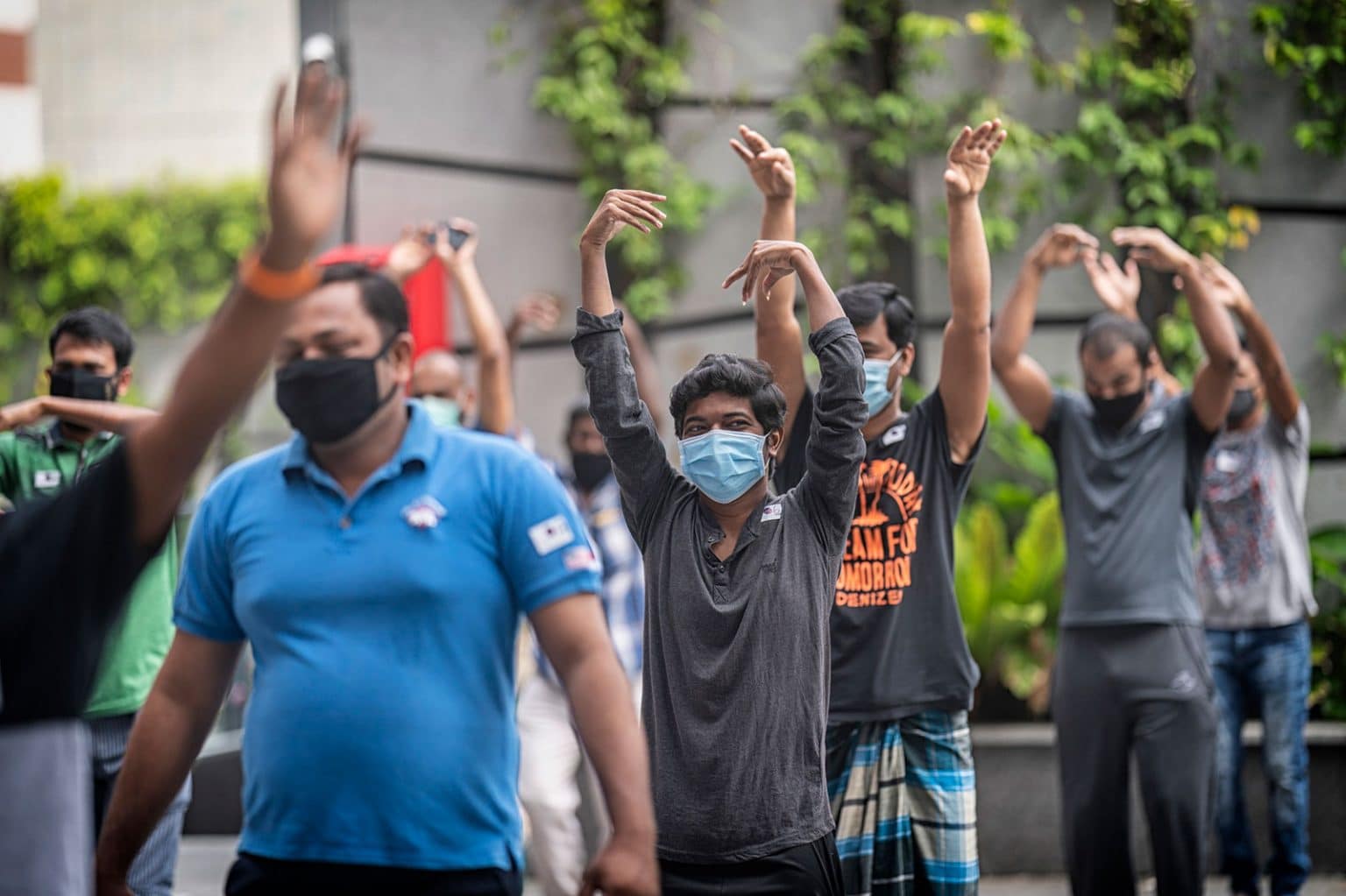 migrant workers doing stretches