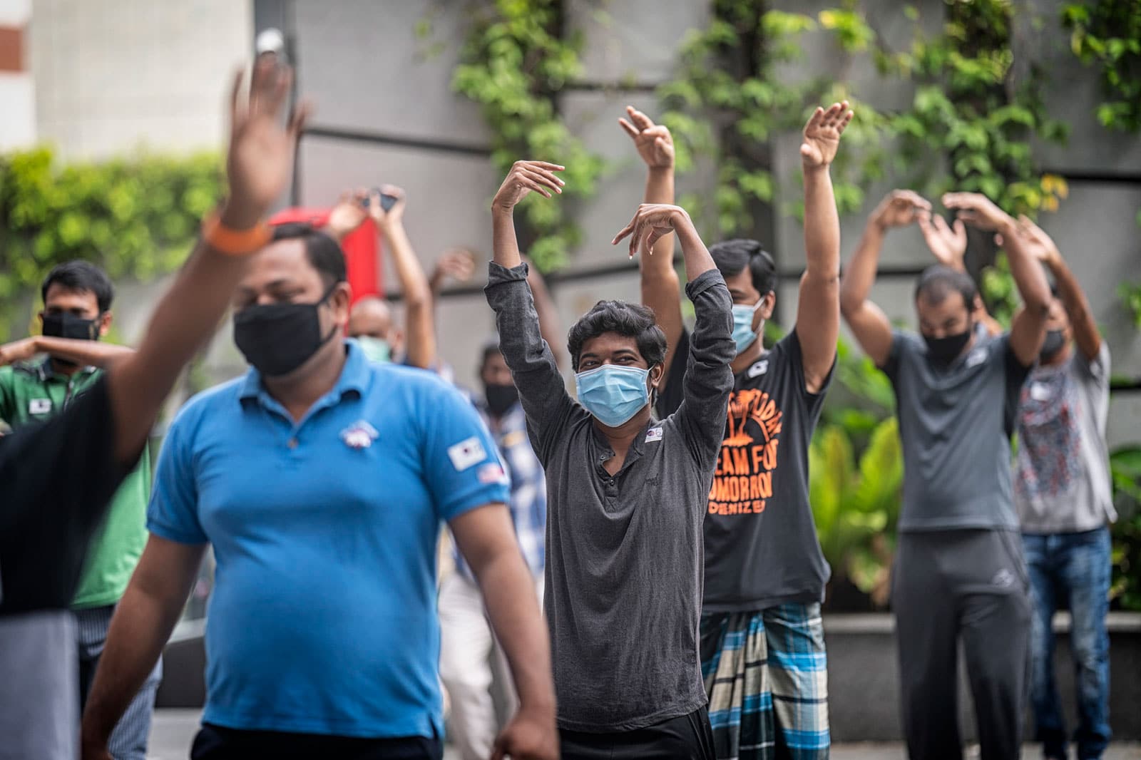 migrant workers doing stretches