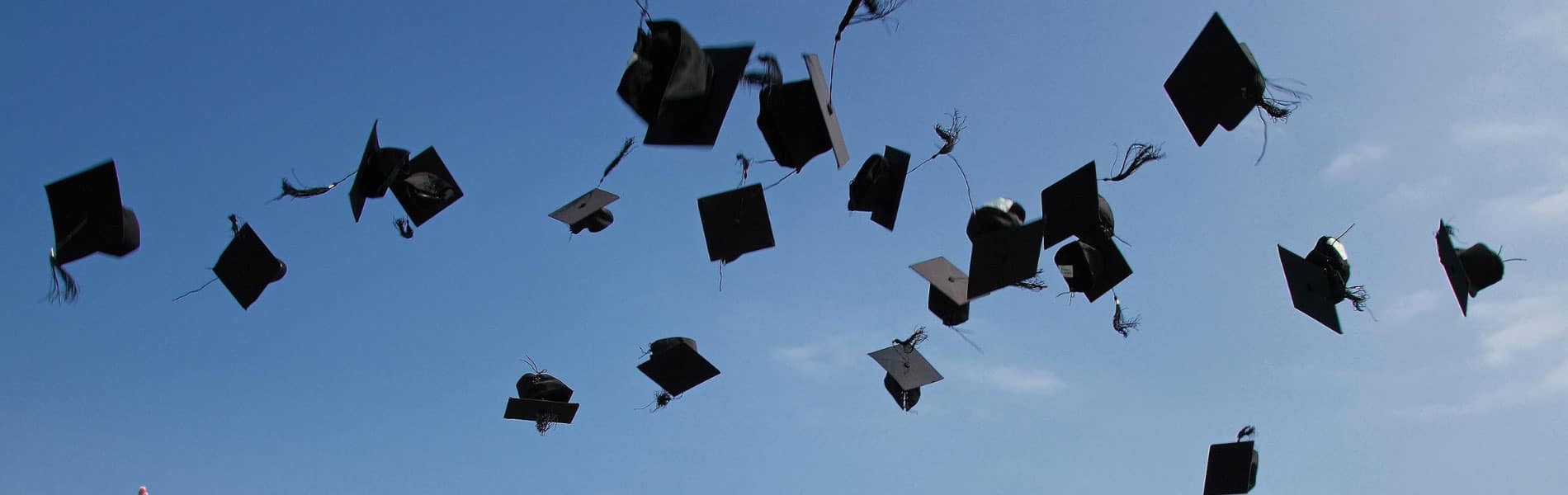 graduation caps being thrown into the air