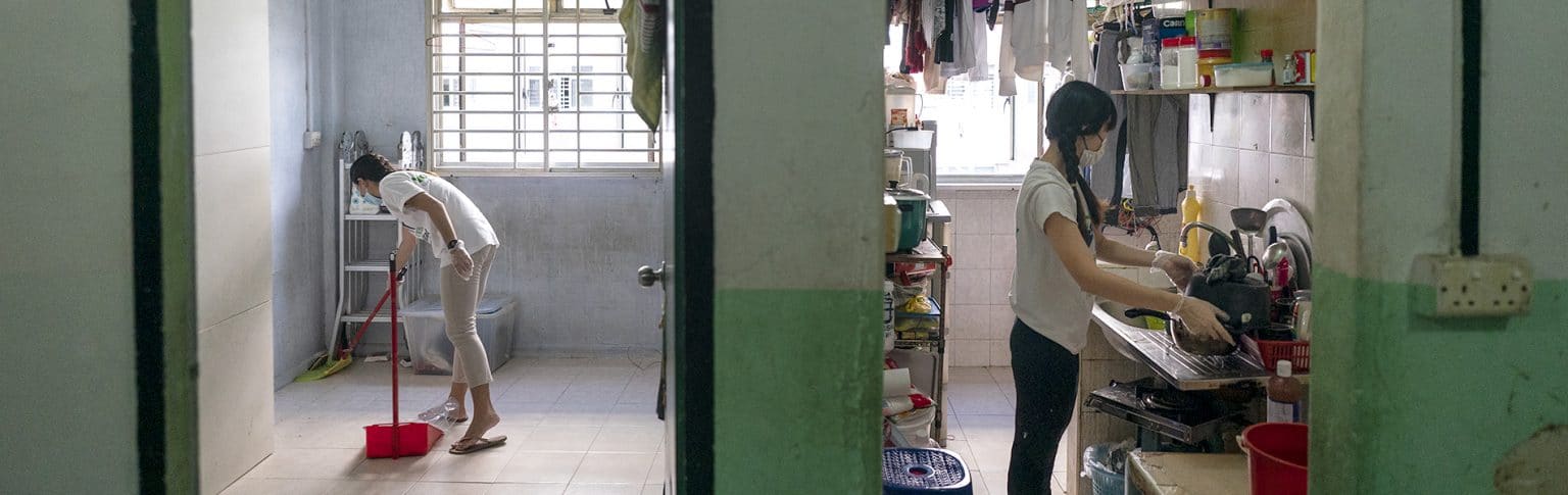 two female volunteers cleaning up a bedroom and a kitchen