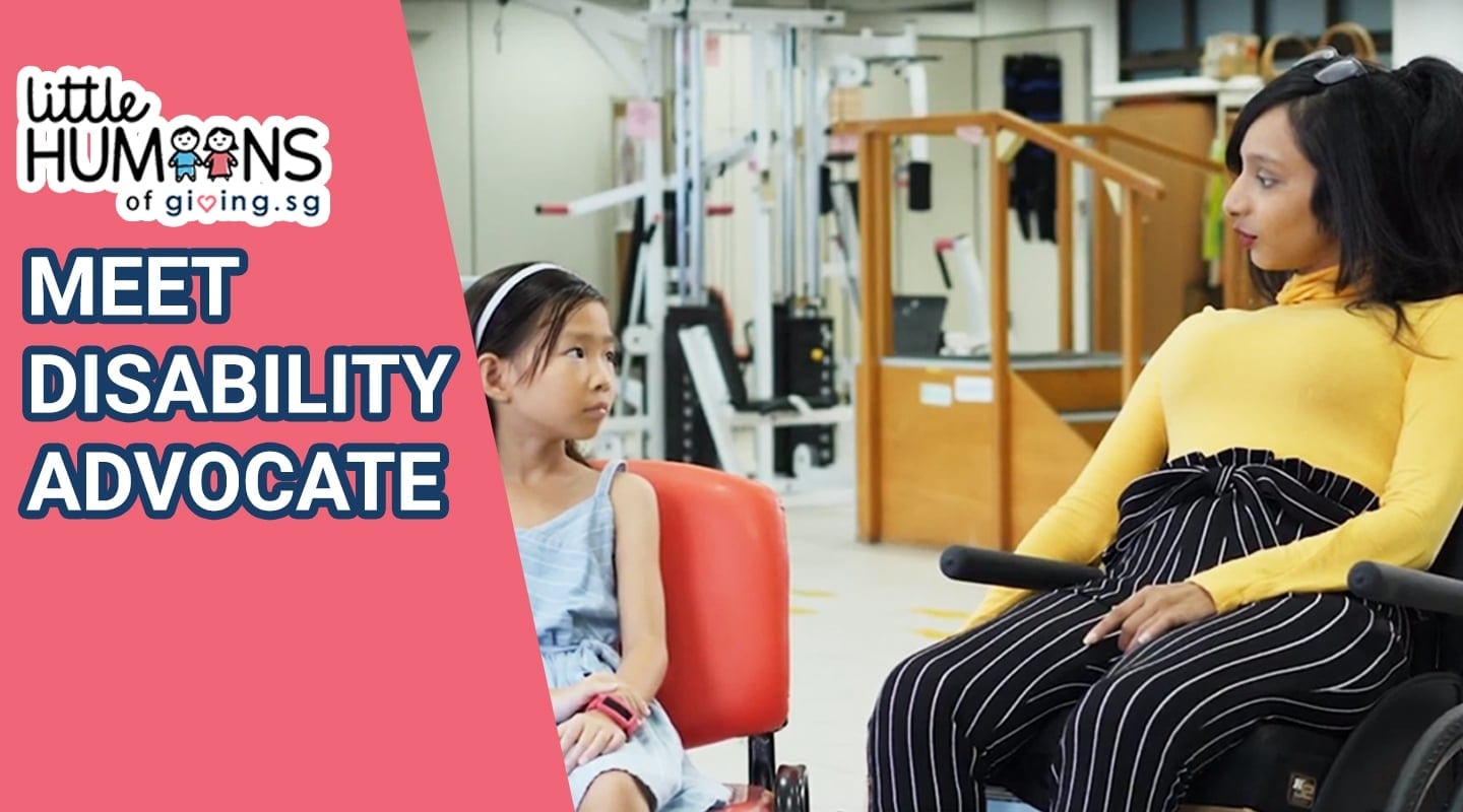 little humans of giving.sg girl in blue dress listening to woman in wheelchair