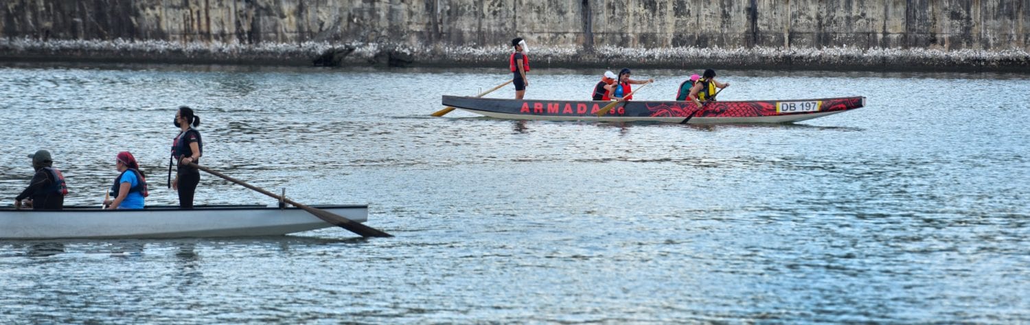 two canoes rowing past each other in a river