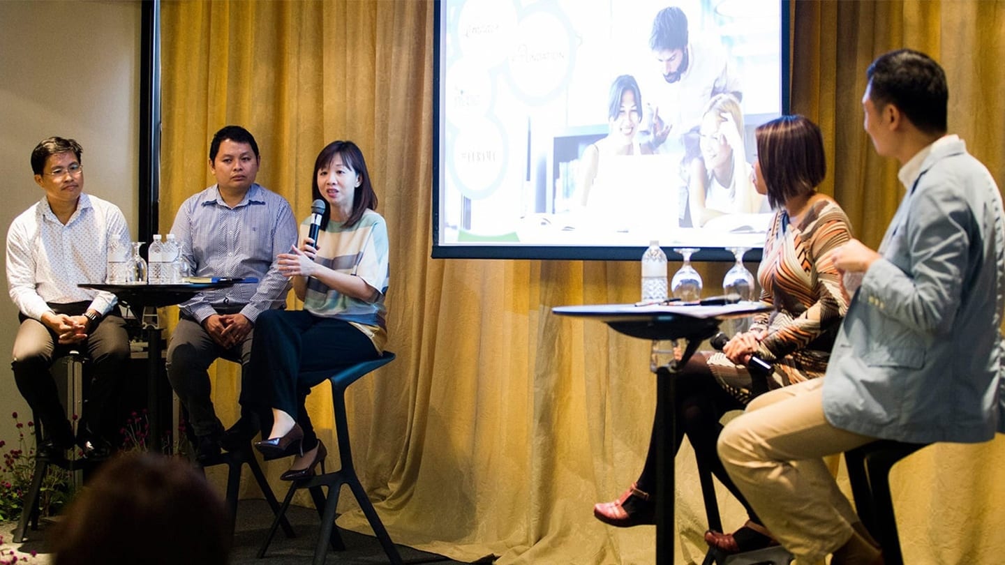 five speakers giving a talk at a conference