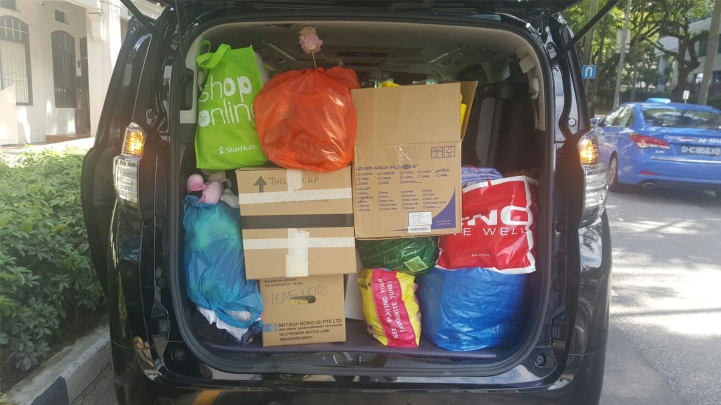 back of car loaded with cardboard boxes and other items