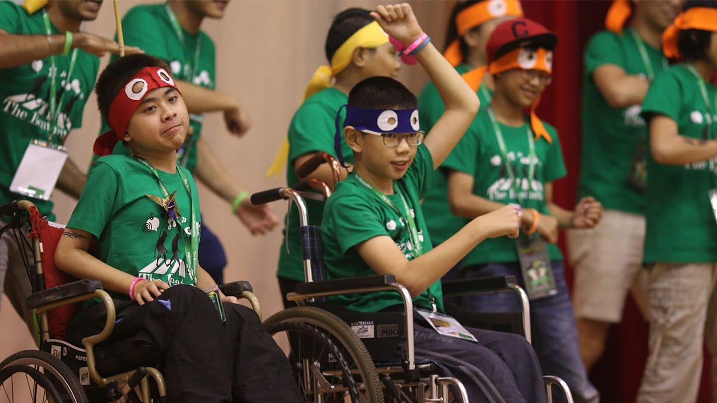 volunteers and special needs children putting up a performance