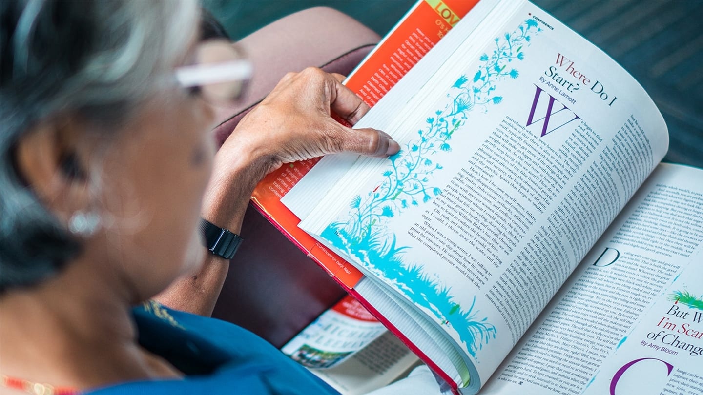 elderly woman reading a book that says where do i start