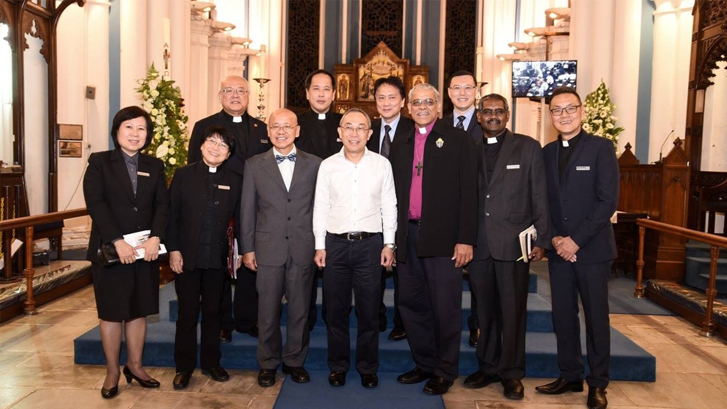 members of the clergy gathered for a photo in church