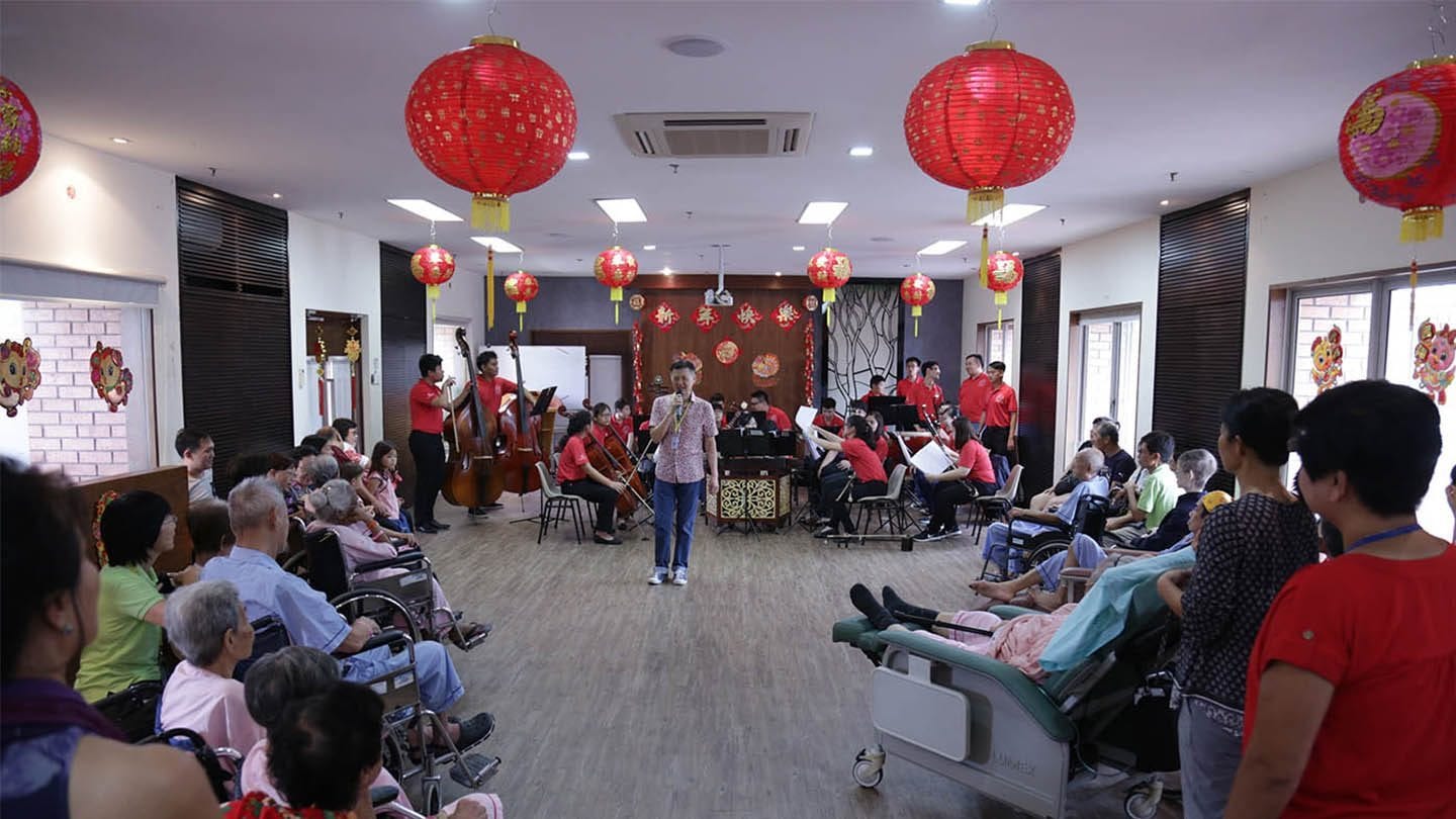 chinese orchestra and singer performing at old folks' home