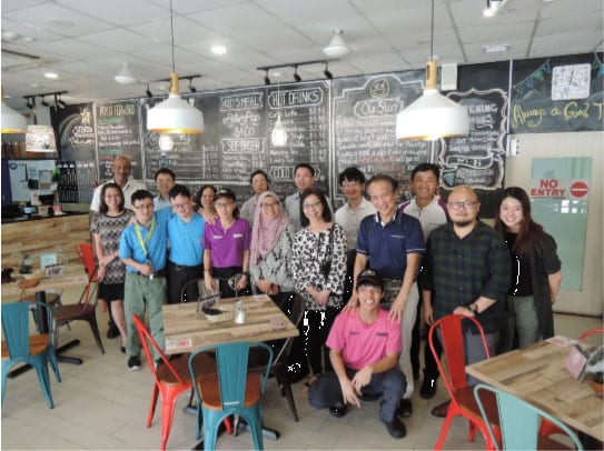 workers at a cafe posing for a picture