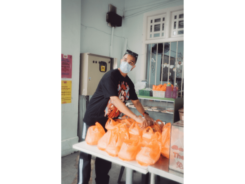 Yung Raja packing food and giving back to community