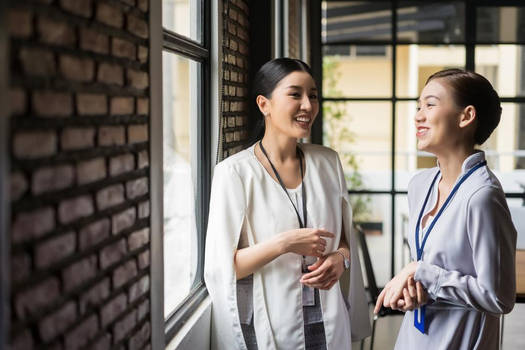 Two women standing and talking