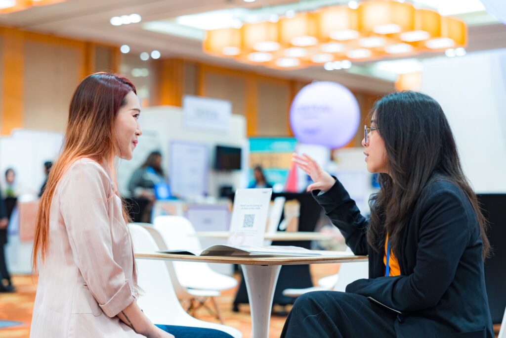 Two ladies having a conversation at the networking section of the exhibition hall