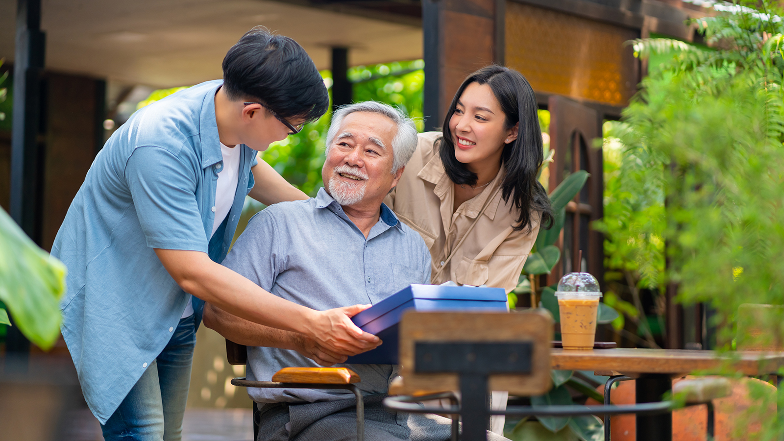 two young adults talking to an old man