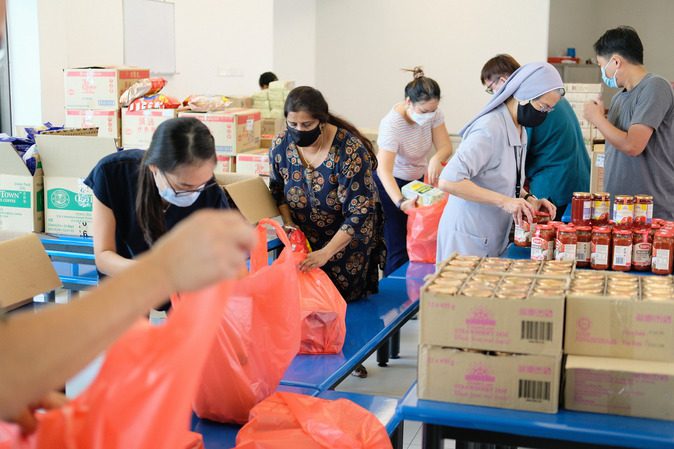 Photo 1 Canossaville Staff Packing Carepacks.JPG
