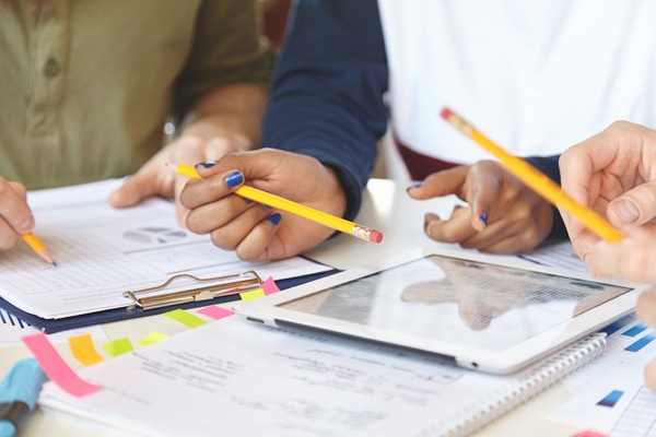 discussing a report with pencils