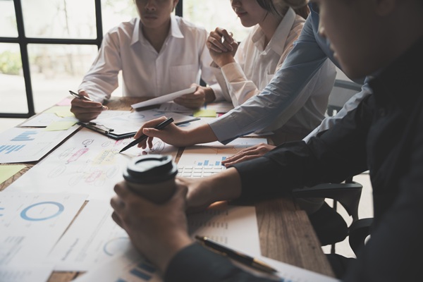 people having a business meeting with coffee cup