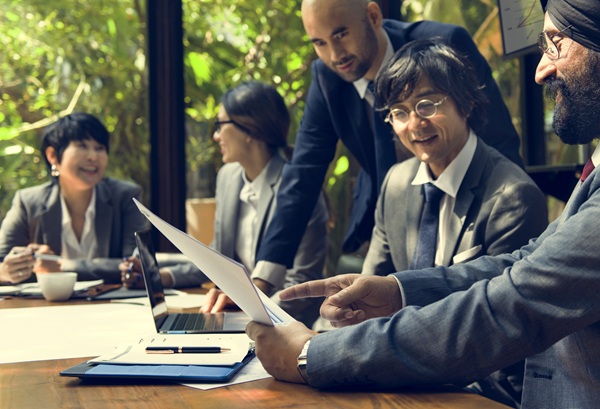 people in suits in office having a meeting