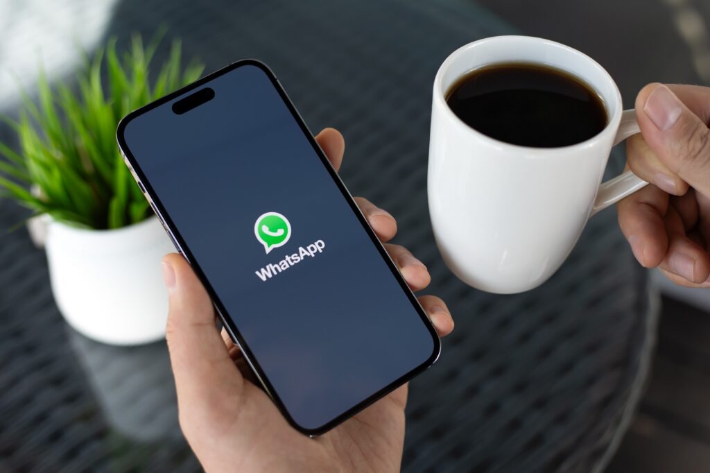 person using whatsapp on phone 1024x682 1