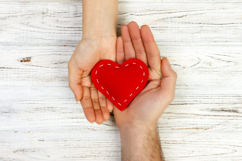 two hands holding a heart scaled 1