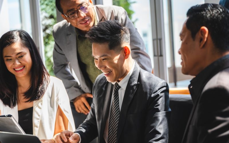 a group of people in business jackets having a discussion